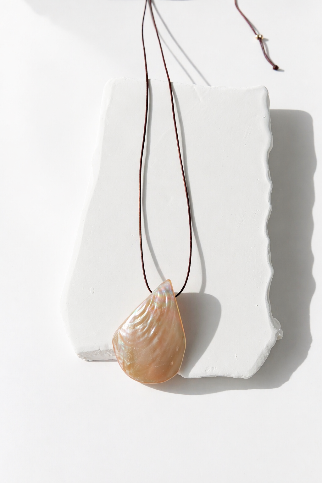 Boho beach necklace for her featuring a mother of pearl shell charm on a cotton thread.